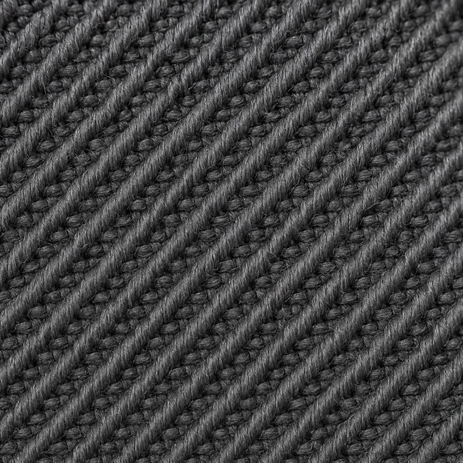 Macro photograph of a charcoal twill weave showing parallel diagonal ribs.